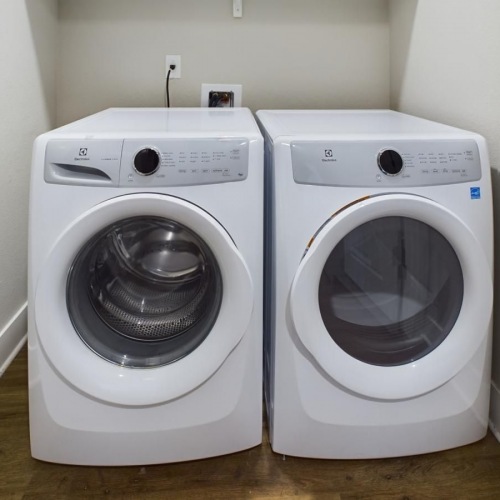 a washing machine and dryer in a room