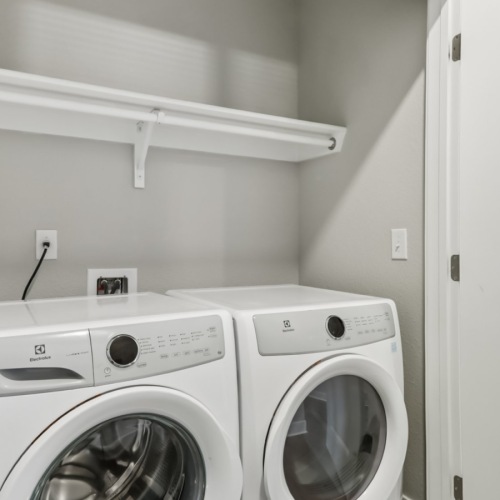 a washing machine and dryer in a room