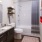 interior rendering of bathroom space with toilet, vanity and bathub