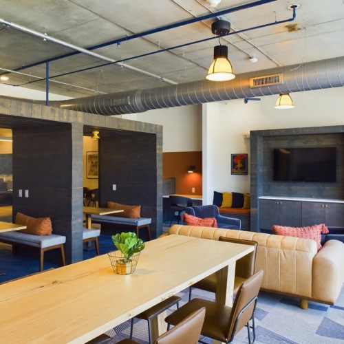 a room with a fireplace and tables